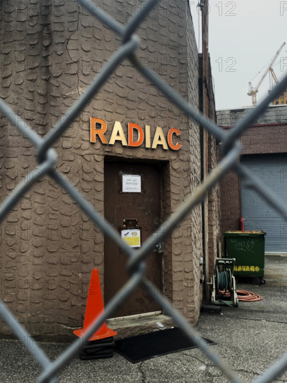 Radiac Research, building exterior viewed through chain link fence, Williamsburg, Brooklyn, New York, USA