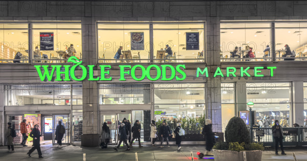 Whole Foods Market, building exterior and sidewalk scene at night, New York City, New York, USA