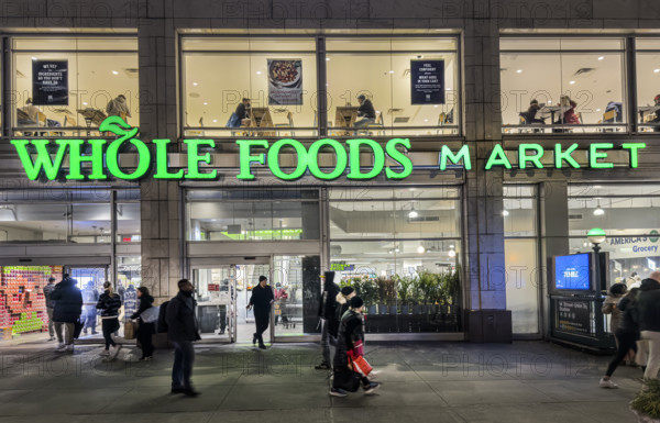Whole Foods Market, building exterior and sidewalk scene at night, New York City, New York, USA
