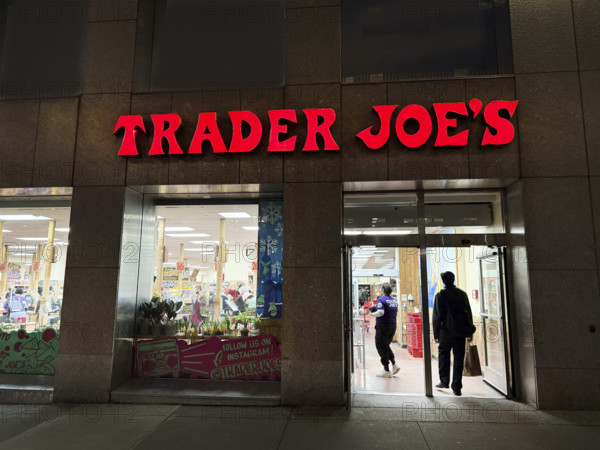 Trader Joe's grocery store, building exterior and entrance at night, New York City, New York, USA