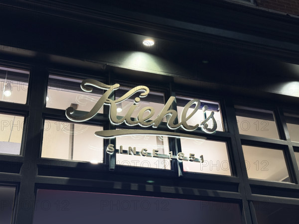 Kiehl's flagship store, company sign on building exterior at night, 109 Third Avenue, New York City, New York, USA