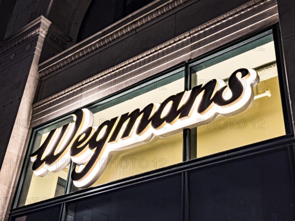 Wegman's, store logo on building exterior at night, New York City, New York, USA