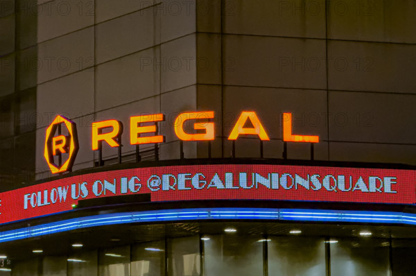 Regal movie theaters, building exterior at night, New York City, New York, USA