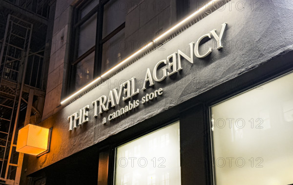 The Travel Agency, a Cannabis Store, building exterior at night, New York City, New York, USA