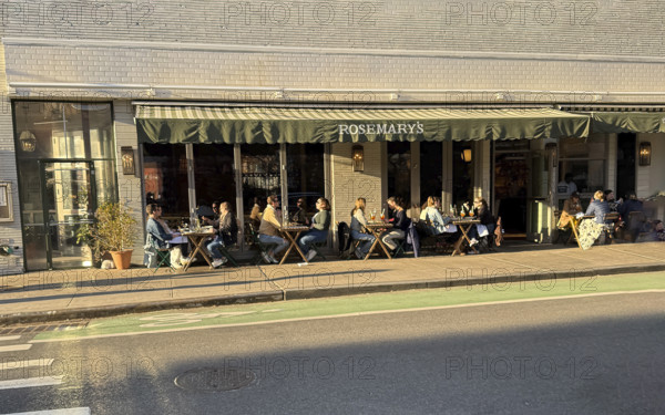 Group of people enjoying outdoor dining on sunny day, Rosemary's Restaurant, New York City, New York, USA