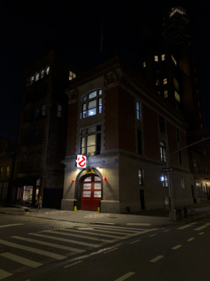 Beaux-Arts style firehouse from 1903 illuminated at night, made famous as the headquarters of the 1984 film, "Ghostbusters", New York City, New York, USA