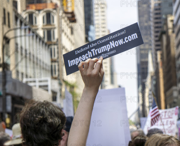 Demonstrators participating in "Our City, Our Fight: Protect Migrants, Protect the Planet" protest, New York City, New York, April 19, 2025