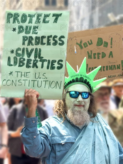 Demonstrators participating in "Our City, Our Fight: Protect Migrants, Protect the Planet" protest, New York City, New York, April 19, 2025