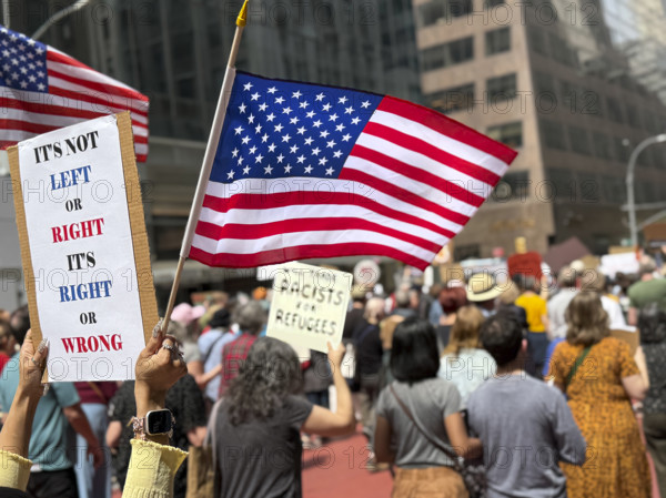 Demonstrators participating in "Our City, Our Fight: Protect Migrants, Protect the Planet" protest, New York City, New York, April 19, 2025