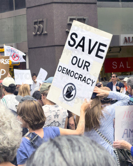 Demonstrators participating in "Our City, Our Fight: Protect Migrants, Protect the Planet" protest, New York City, New York, April 19, 2025