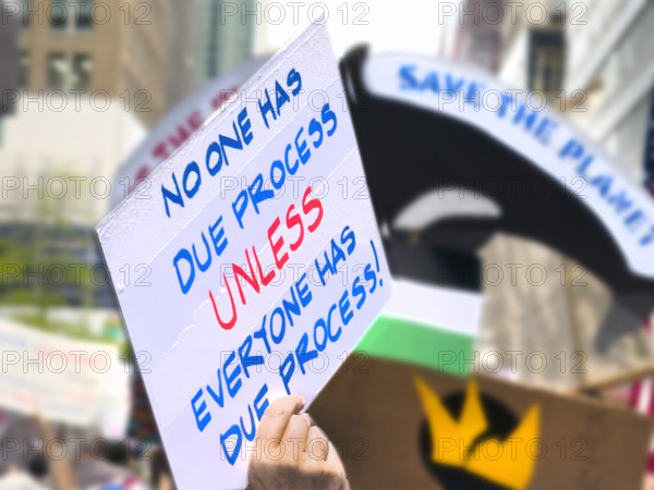 Demonstrators participating in "Our City, Our Fight: Protect Migrants, Protect the Planet" protest, New York City, New York, April 19, 2025