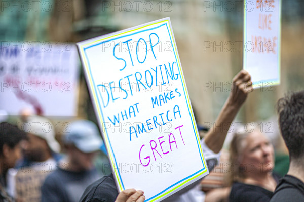 Demonstrators participating in "Our City, Our Fight: Protect Migrants, Protect the Planet" protest, New York City, New York, April 19, 2025