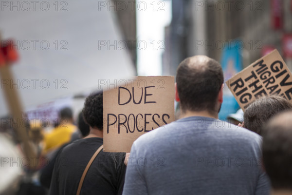Demonstrators participating in "Our City, Our Fight: Protect Migrants, Protect the Planet" protest, New York City, New York, April 19, 2025