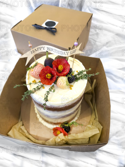 Pistachio birthday cake with buttercream frosting and edible flowers