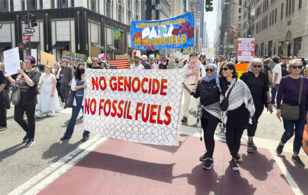 Demonstrators participating in "Our City, Our Fight: Protect Migrants, Protect the Planet" protest, New York City, New York, April 19, 2025