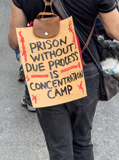 Demonstrator participating in "Our City, Our Fight: Protect Migrants, Protect the Planet" protest, New York City, New York, April 19, 2025