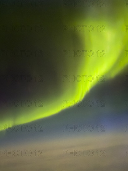 Bright green Northern Lights over Hudson Bay, Nunavut, Canada