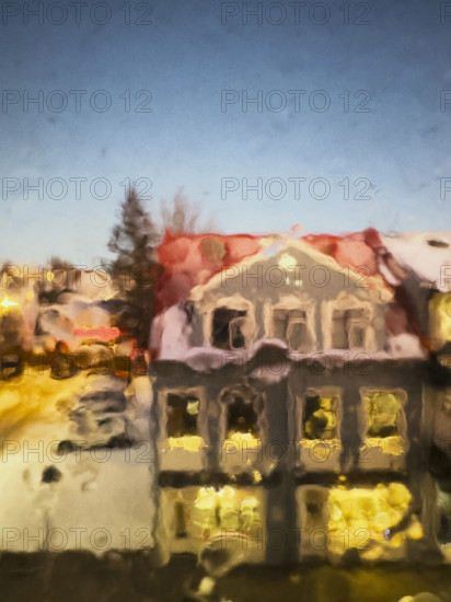 Street scene viewed through blurred raindrops on window, Hafnarfjordur, Iceland