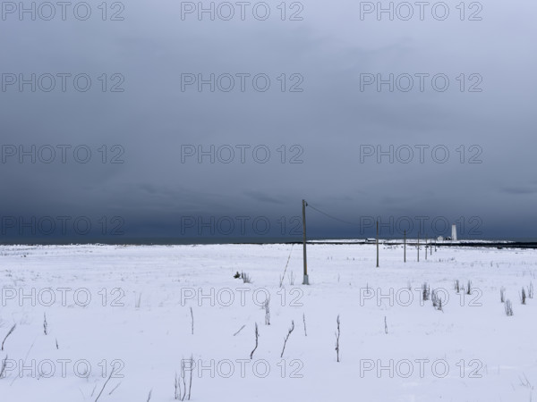 Snowy field with dramatic gray sky