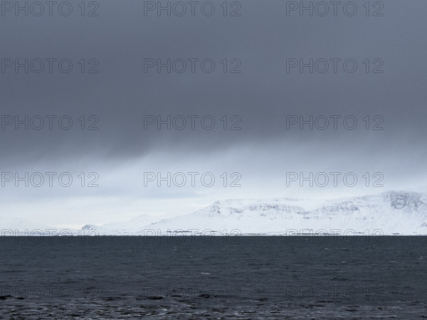 Mt. Esja viewed across inlet from Seltjarnarnes, Capital Region, Iceland on moody winter day