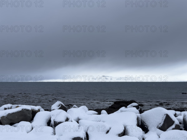 Mt. Esja viewed across inlet from Seltjarnarnes, Capital Region, Iceland on moody winter day