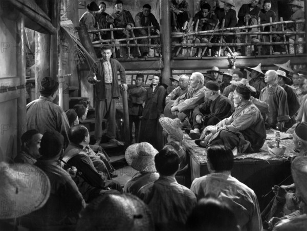 Turhan Bey (standing on steps), Katharine Hepburn (standing right of Bey), on-set of the film, "Dragon Seed,", MGM, 1944