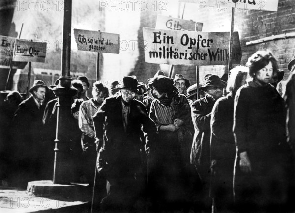 Beggars marching in protest scene, on-set of the German musical film, "The Threepenny Opera", German title: "Die 3 Groschen-Oper", Nero-Film, Tobis Filmkunst, Warner Bros. Pictures GmbH, 1931