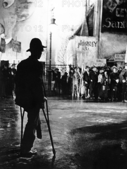 Beggars marching in protest scene, on-set of the German musical film, "The Threepenny Opera", German title: "Die 3 Groschen-Oper", photo by Hans Casparius, Nero-Film, Tobis Filmkunst, Warner Bros. Pictures GmbH, 1931
