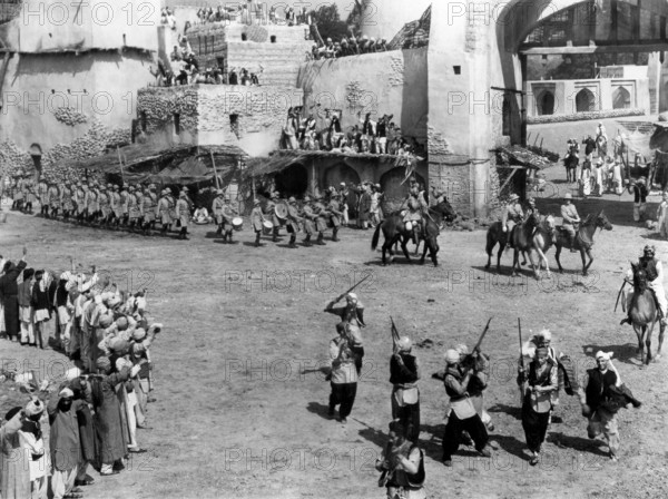 Scottish regiment marching into Indian village, on-set of the British film, "The Drum", U.S. title: "Drums", United Artists, 1938