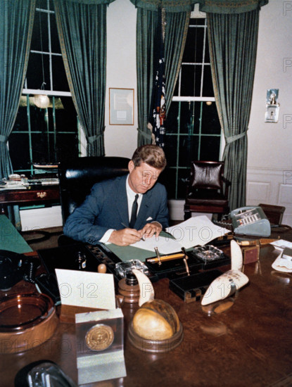 U.S. President John F. Kennedy signing the Interdiction of the Delivery of Offensive Weapons to Cuba during Cuban Missile Crisis, Oval Office, White House, Washington, D.C., USA, Cecil W. Stoughton, White House Photographs, October 23, 1962