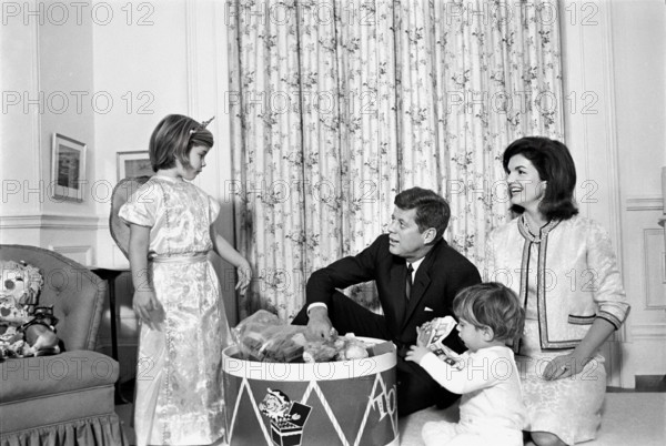 U.S. President John F. Kennedy and U.S. First Lady Jacqueline Kennedy visit with their children, Caroline Kennedy and John F. Kennedy, Jr., in John’s nursery, following a joint birthday party for the children. White House, Washington, D.C., USA, Cecil W. Stoughton, White House Photographs, November 27, 1962