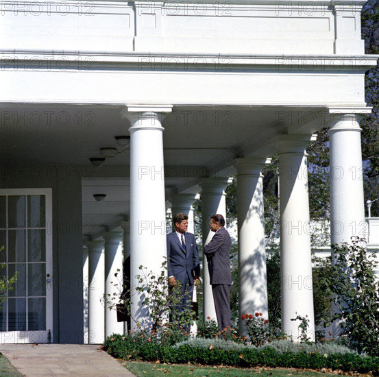 U.S. President John F. Kennedy speaking with U.S. Secretary of Defense Robert S. McNamara (right) in the West Wing Colonnade outside the Oval Office during meeting with the Executive Committee of the National Security Council that day regarding the crisis in Cuba, White House, Washington, D.C., USA, Cecil W. Stoughton, White House Photographs, October 29, 1962