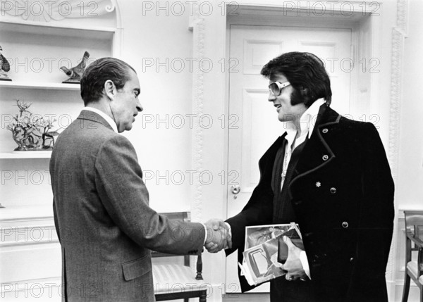 U.S. President Richard Nixon shaking hands with Elvis Presley during open hour in the Oval Office, White House, Washington, D.C., USA, White House Photo Office, December 21, 1970