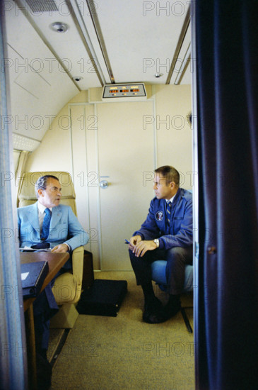 U.S. President Richard M. Nixon seated with White House Chief of Staff Harry Robbins "H.R." Haldeman on board Air Force One inside a private cabin enroute to China, White House Photo Office, February 20, 1972