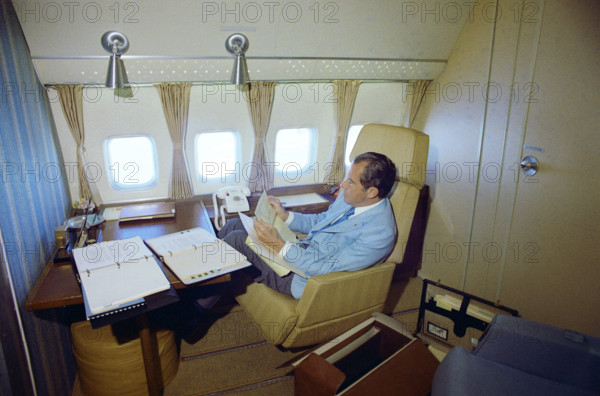 U.S. President Richard M. Nixon seated on board Air Force One inside a private cabin enroute to China, White House Photo Office, February 20, 1972
