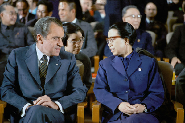 U.S. President Richard M. Nixon sitting with Jiang Qing, wife of Chairman Mao Zedong, during Revolutionary Opera performance, "Red Detachment of Women" at the Great Hall of the People, Beijing, China, White House Photo Office, February 22, 1972