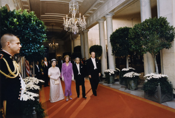 Japanese Empress Nagako, U.S. First Lady Betty Ford, Japanese Emperor Hirohito, and U.S. President Gerald Ford walking down the Cross Hall toward the East Room prior to a state dinner held in honor of the Japanese heads of state, White House, Washington, D.C., USA, Karl H. Schumacher, White House photographer, October 2, 1975