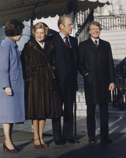 U.S. President Gerald Ford, U.S. First Lady Betty Ford, U.S. President-Elect Jimmy Carter, and Rosalynn Carter standing under canopy near south portico following the Carters' tour of the White House, Washington, D.C., USA, Thomas, Ricardo, White House photographer, November 22, 1976