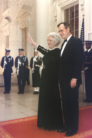 U.S. President George H.W. Bush and U.S. First Lady Barbara Bush await the arrival of President Ali Abdallah Saleh of the Yemen Arab Republic for a State Dinner at the White House, Washington, D.C., USA, Susan Biddle, White House photographer, January 24, 1990