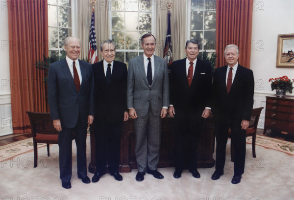 U.S. President George H.W. Bush participating in group photo with former U.S. Presidents Gerald Ford, Richard Nixon, Ronald Reagan and Jimmy Carter in the replica of the Oval Office at the Dedication of the Ronald Reagan Presidential Library, Simi Valley, California, USA, David Valdez, White House photographer, November 4, 1991