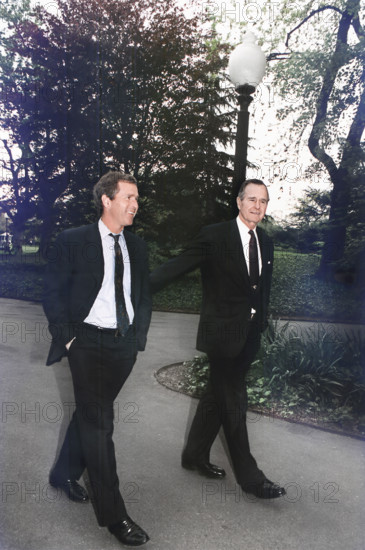 U.S. President George H.W. Bush walking up the south lawn towards the Oval Office with his son, George W. Bush, White House, Washington, D.C., USA, David Valdez, White House photographer, April 29, 1992