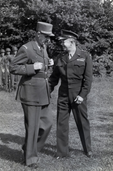 French General Charles de Gaulle, left, chatting with U.S. General Dwight D. Eisenhower during inspection of U.S. troops at the Allied commander's advance headquarters, Normandy, France, U.S. Army Signal Corps, August 22, 1944