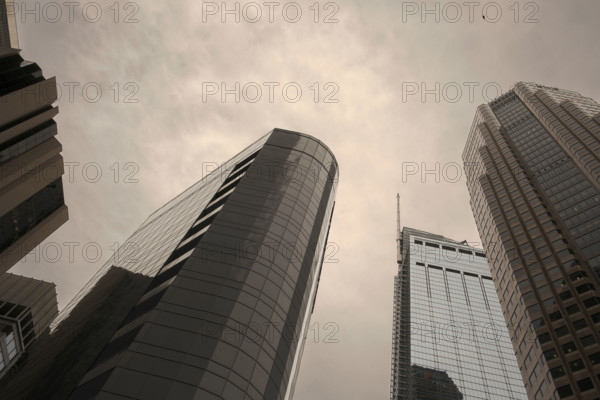 Low angle view of office buildings against cloudy sky, Los Angeles
