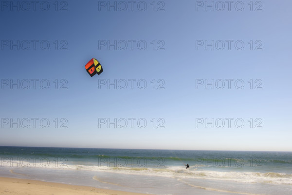 Kite surfer catching a wave