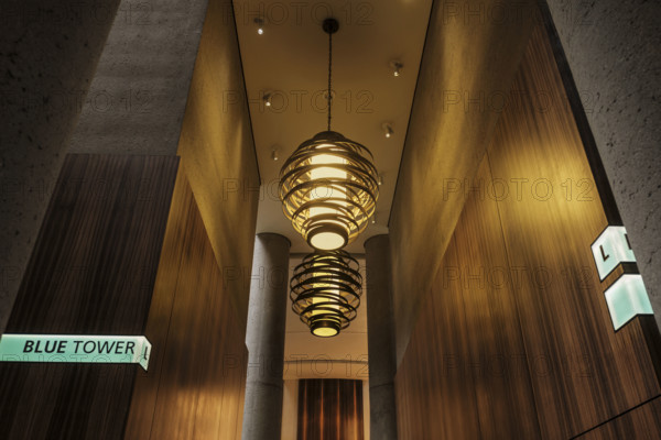 Two large spiral pendant lights in hotel lobby