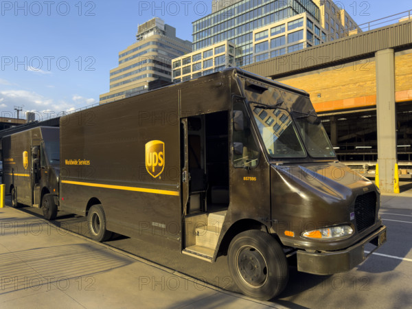 UPS delivery trucks parked on street, New York City