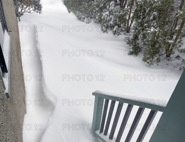 View of snowdrifts from back porch of residential home
