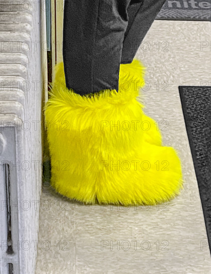 Woman wearing bright yellow furry boots