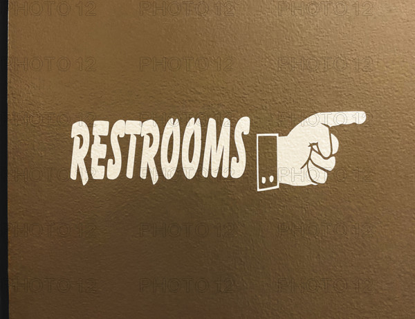 hand symbol pointing way to restrooms