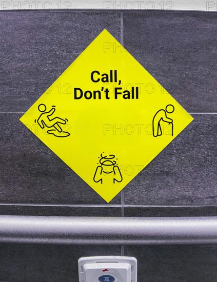 Yellow call for help sign in hospital bathroom
